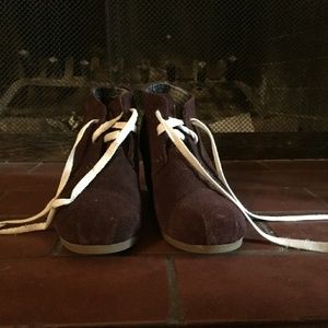 Wedge heels, brown Tom boots with white laces.